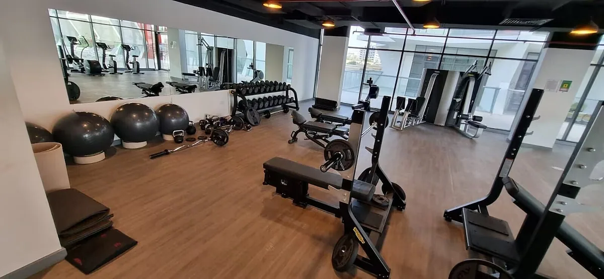 Gym with free weights, benches and cardio machines